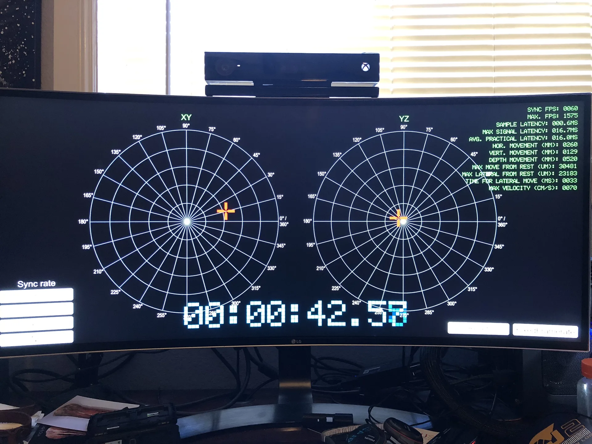 A curved monitor showing two polar plots labeled XY and YZ with crosshairs and a running timer.